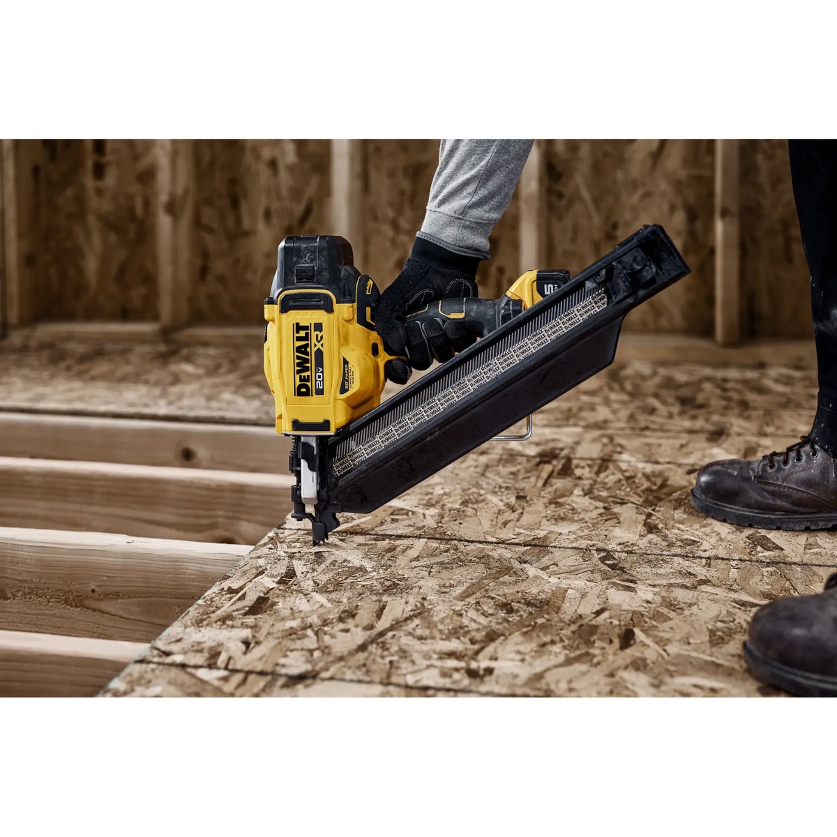 DEWALT DZN930 30 Degree Cordless Framing Nailer Extended Magazine installed on a cordless framing nailer driving into OSB subfloor on a framing jobsite