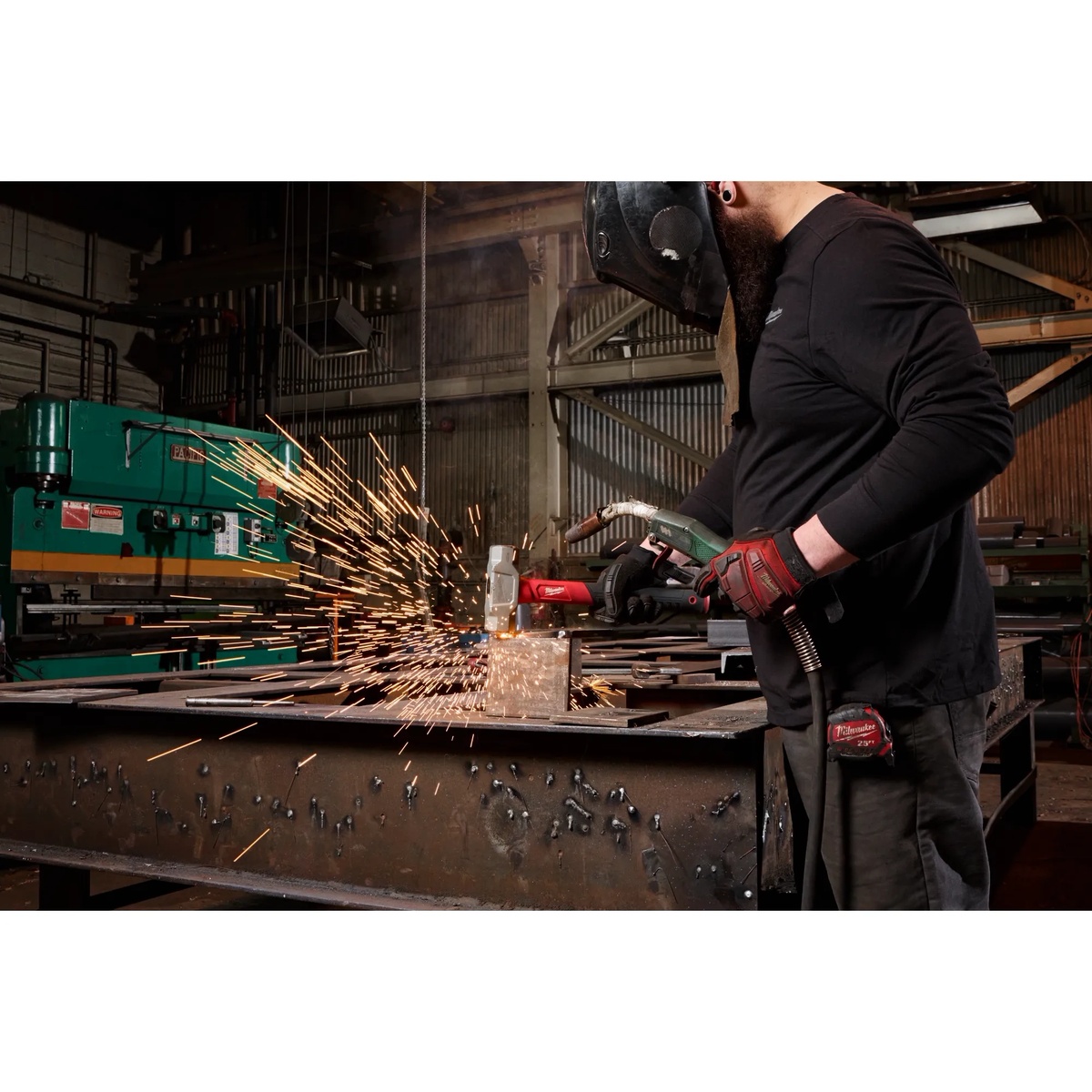 Milwaukee 48-22-9314 4 lb Fiberglass Engineer Hammer used in a metalworking shop for tough striking and demolition tasks in a real jobsite environment