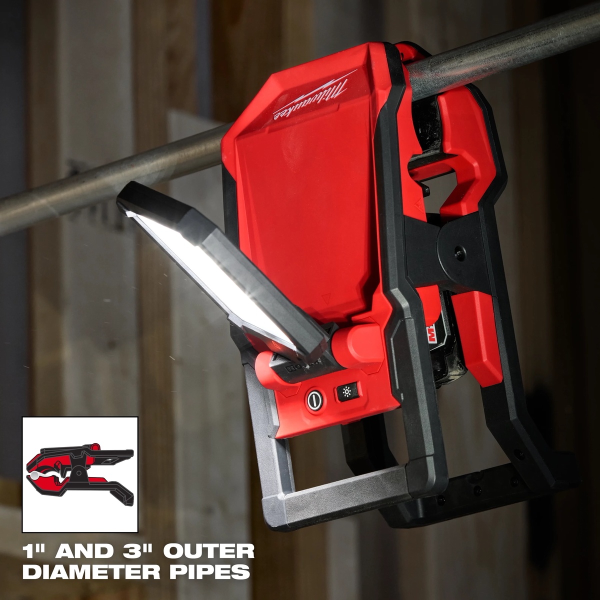 Milwaukee M18 ROVER Clamping Flood Light secured to overhead pipe for hands-free jobsite lighting