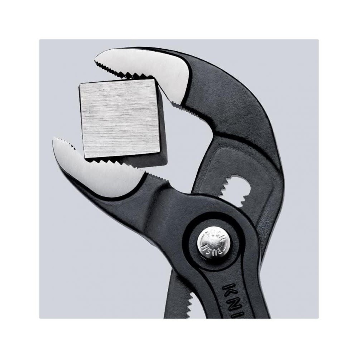Close-up of Knipex 87 01 250 SBA 10 in. Cobra Water Pump Pliers hardened jaws gripping square metal stock in workshop use