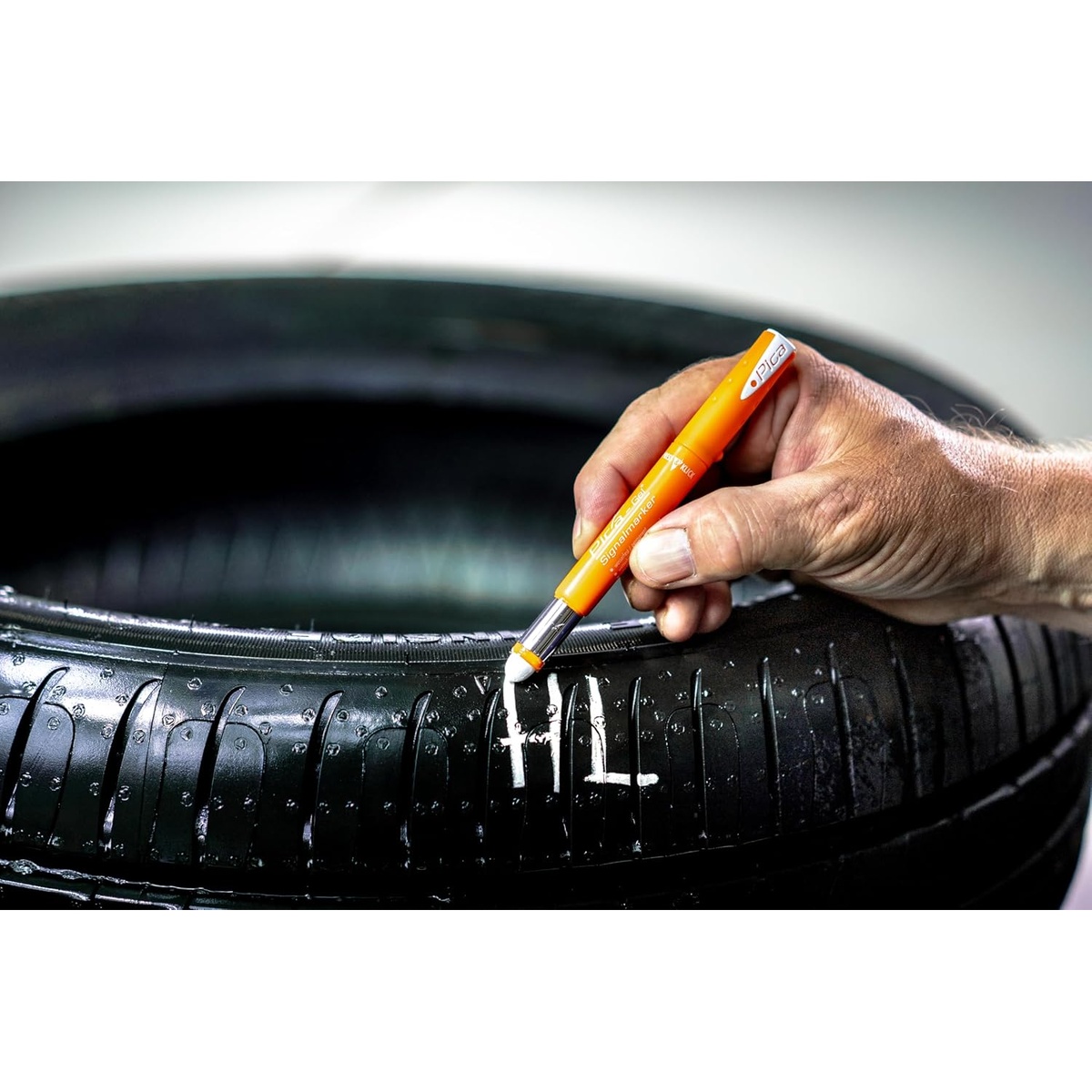 Pica 8082/SB Gel Signal Marker Red 3 Pack marking a wet black tire during automotive service work