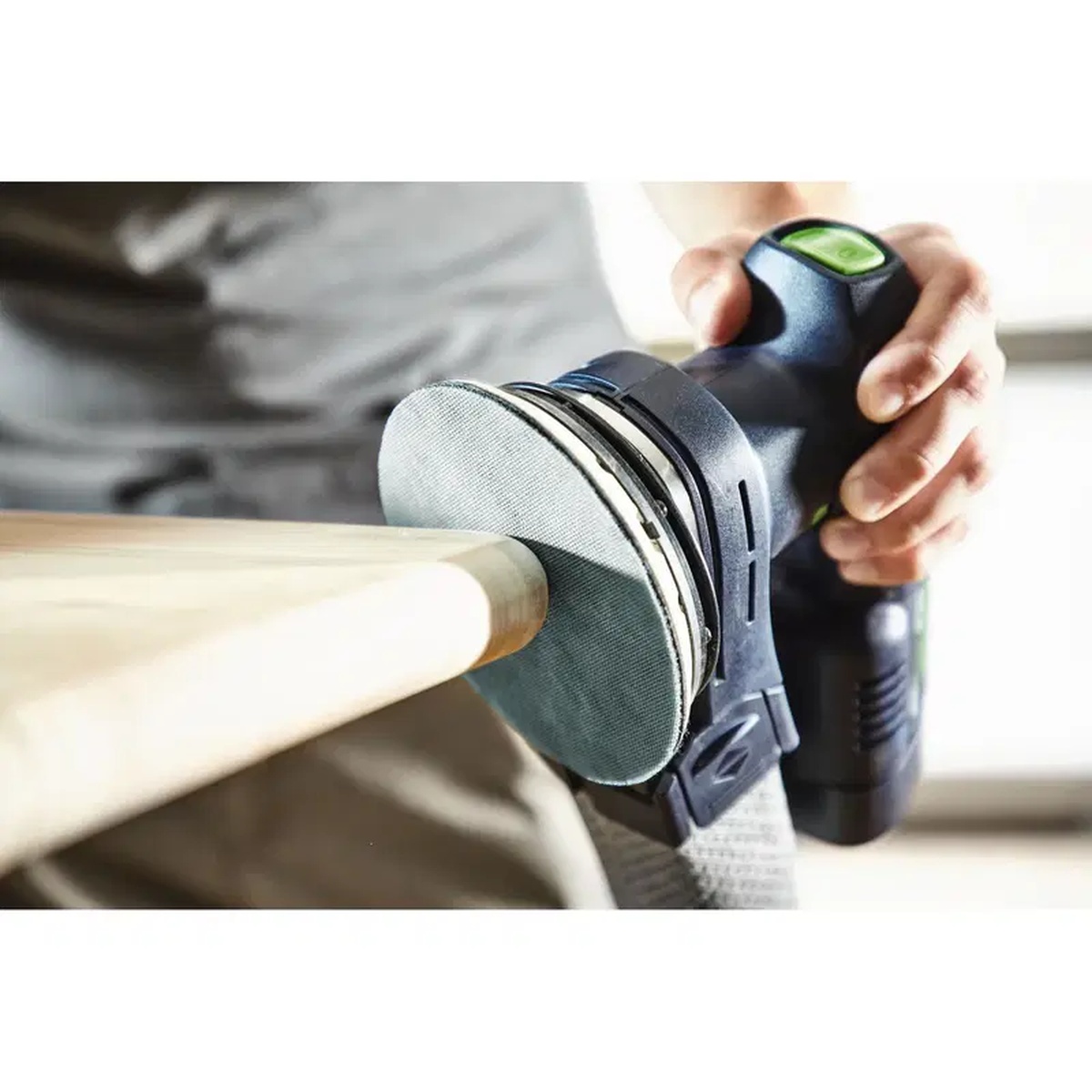 Festool 203306 Granat Net P150 Grit 6-Inch abrasive sanding disc sanding a wood edge with a cordless sander during finish prep work