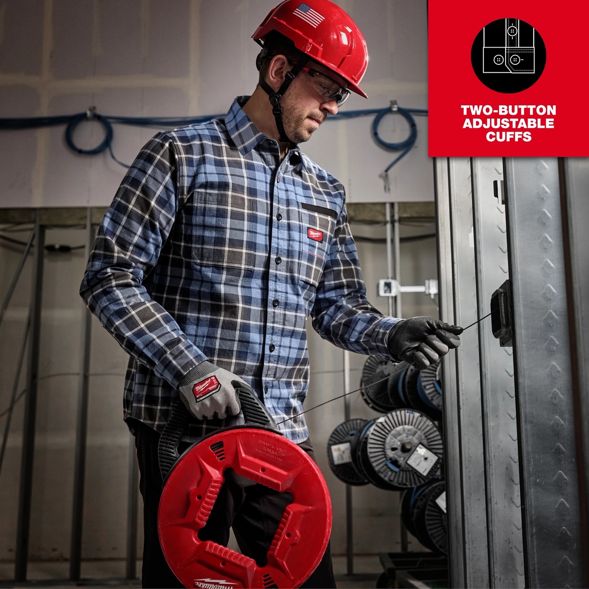 Milwaukee GRIDIRON Flannel Work Shirt worn during electrical rough-in work, showing chest pocket access and sleeve movement on an indoor jobsite