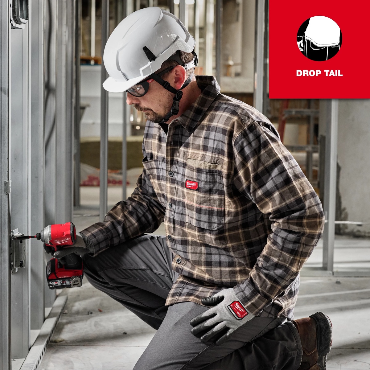 Milwaukee GRIDIRON Flannel Work Shirt used during interior construction fastening work, showing long-sleeve coverage while kneeling on a jobsite