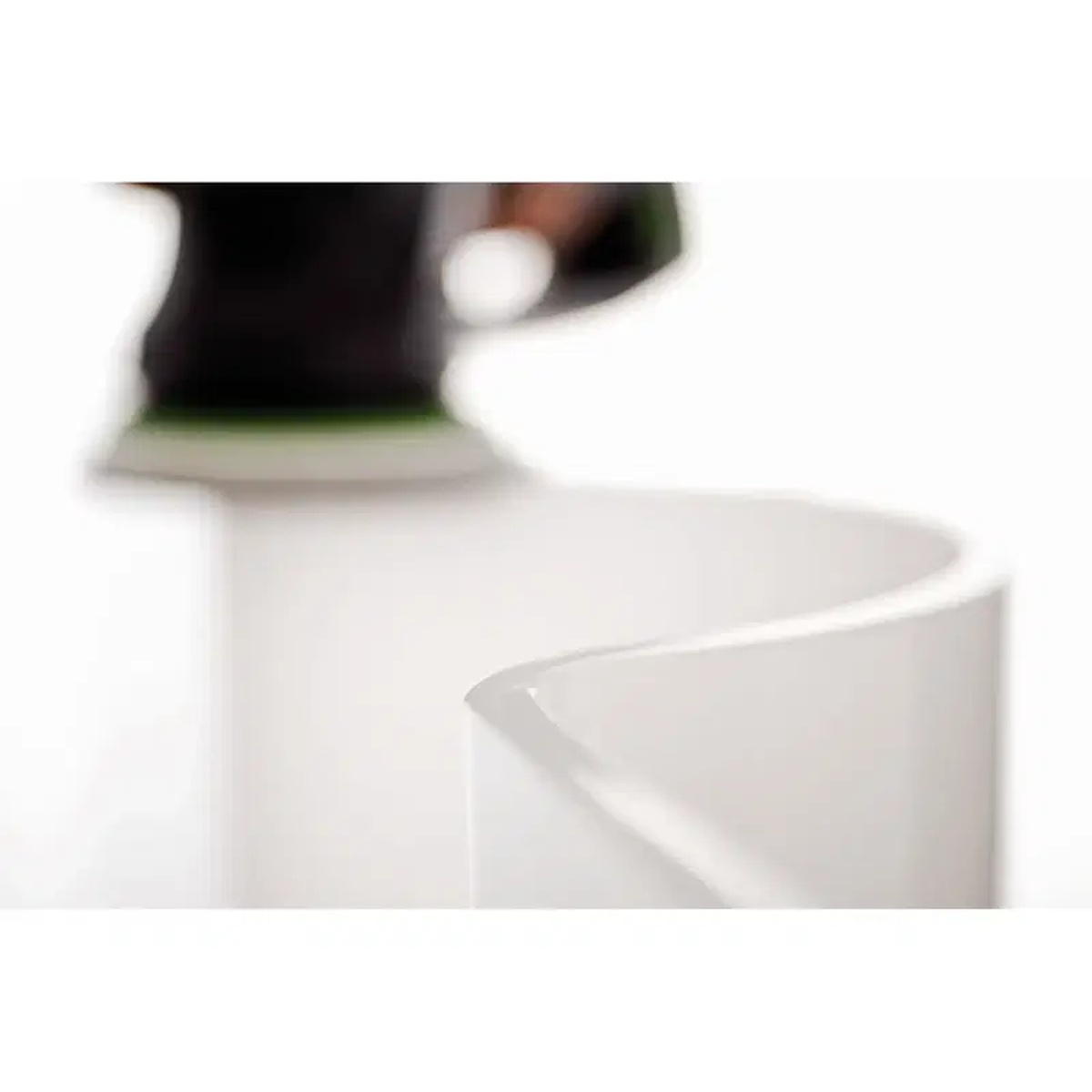5 inch Festool sanding disc refining a coated curved surface during finish preparation work