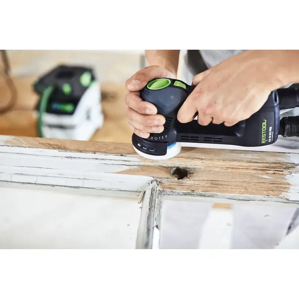 Festool Granat D90 P60 GR/50 sanding discs used on a Festool RO 90 DX sander to strip old paint and worn finish from a wood window frame during refinishing work