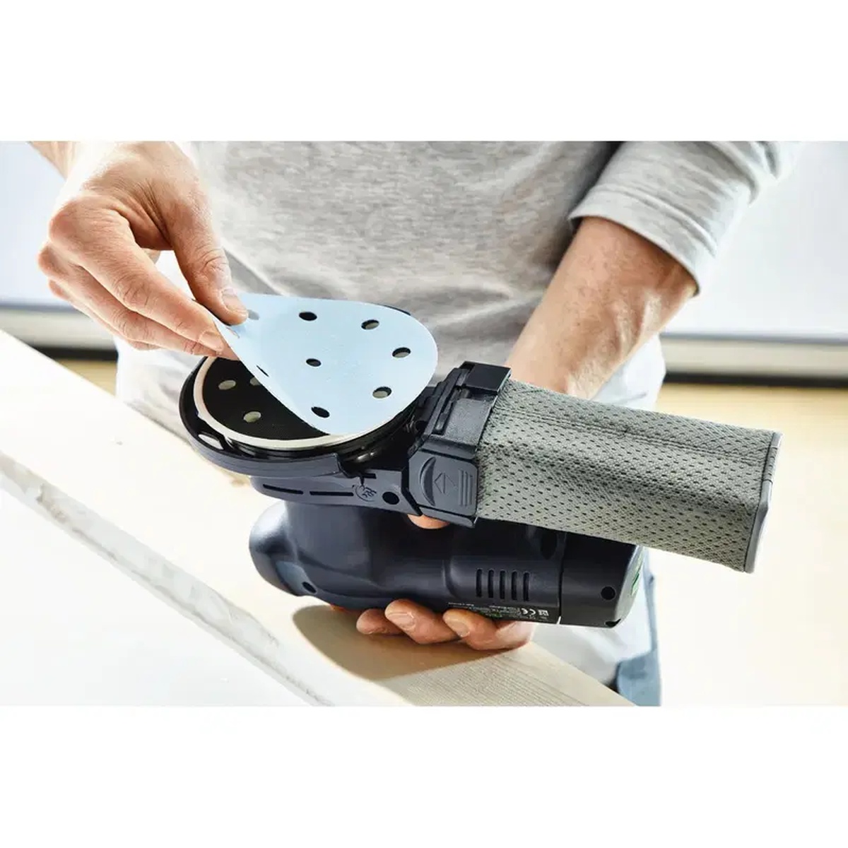 Festool Granat Sanding Abrasive - STF D150/48 - P80 - 50 Pack being applied to a detail sander pad for sanding painted or filled surfaces