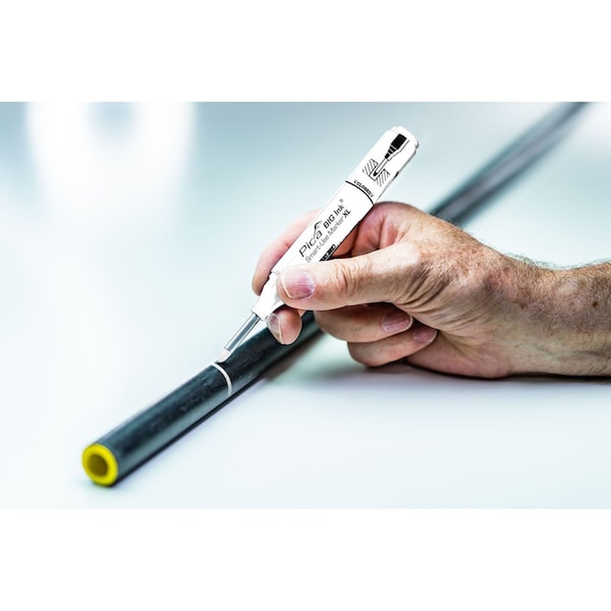 Pica Big Ink Smart-Use Marker XL white marking pvc pipe in a workshop setting