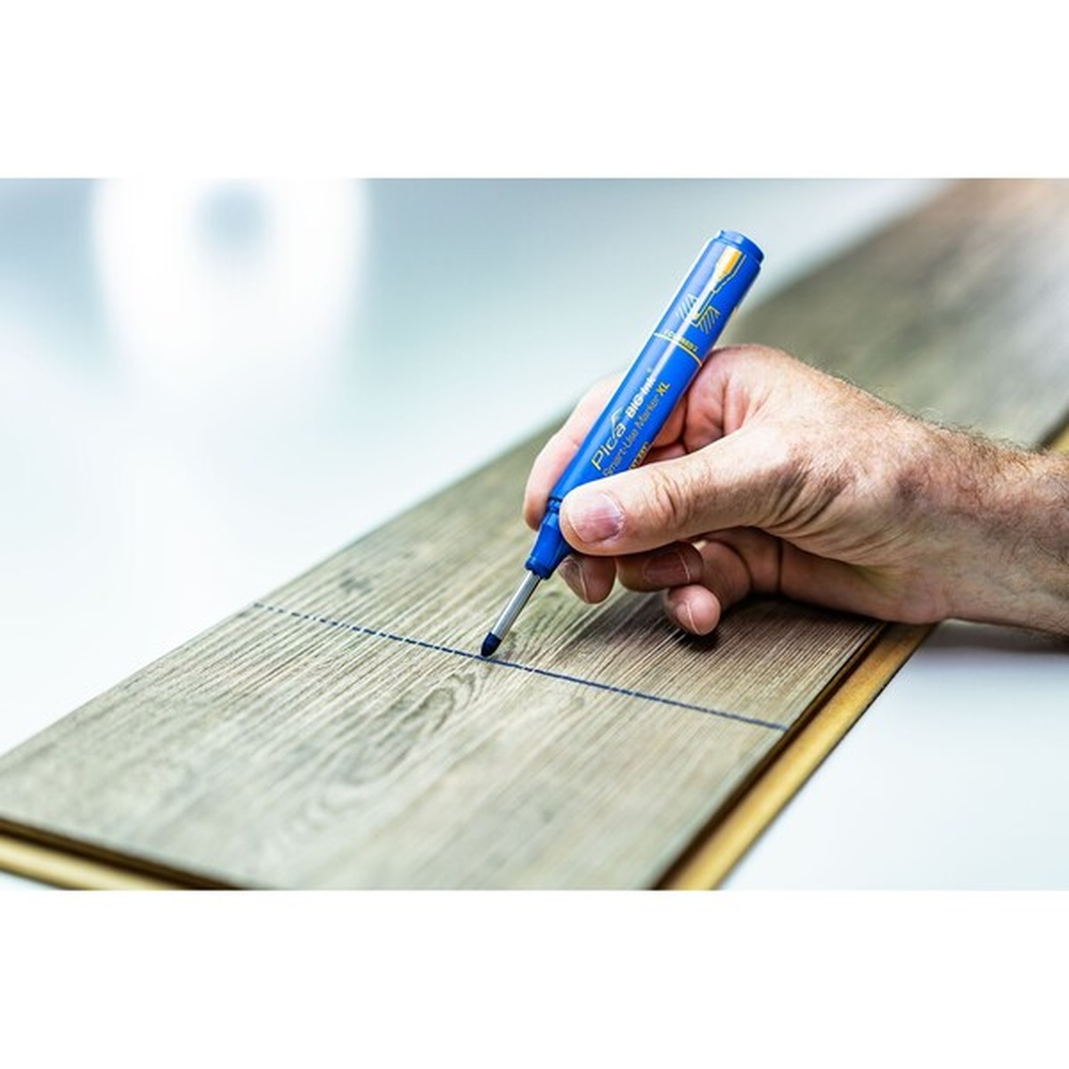 Pica 170/41/SB Blue Ink Marker For Deep Hole making a layout line on wood flooring during installation work