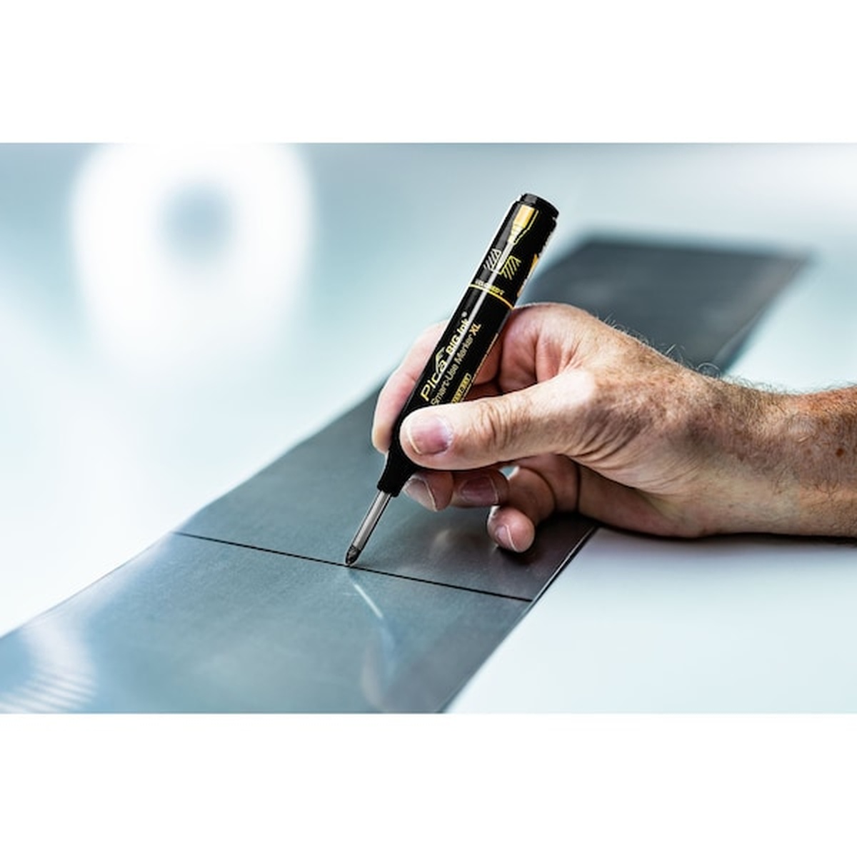 Pica 170/46/SB Black Ink Marker For Deep Hole making a visible layout line on sheet metal in a fabrication setting