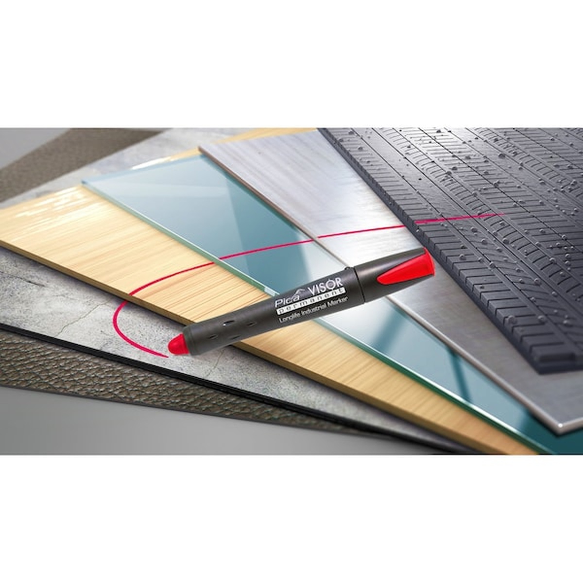 Pica 990/41/SB Visor Permanent Marker marking layout lines across wood, glass, and textured material during jobsite measuring and cutting work