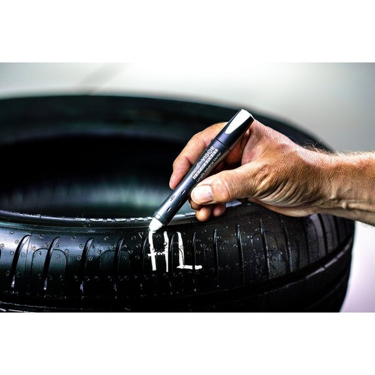 Pica 990/52/SB Visor Permanent Marker making a white mark on a wet black tire during automotive inspection work