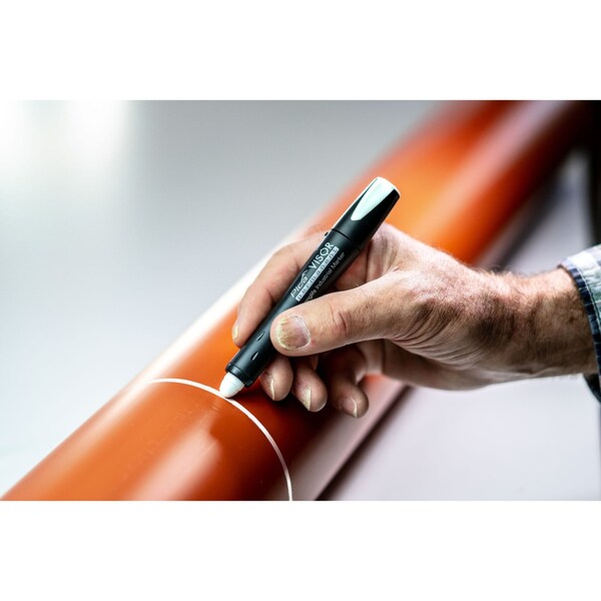 Pica 990/52/SB Visor Permanent Marker marking a PVC pipe line during plumbing or layout work