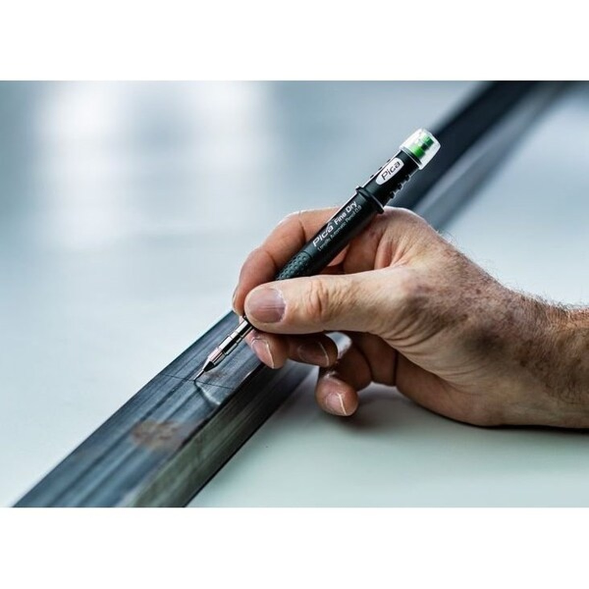 Pica Dry 7030 Fine Dry Set of 24 HB Graphite Refill Leads marking a steel section with a Pica Fine Dry marker during metal layout work