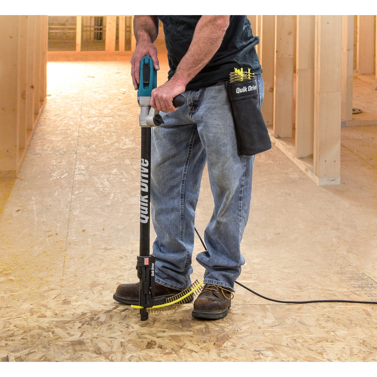 Simpson Strong-Tie Strong-Drive Subfloor Collated Screw being installed with a Quik Drive tool on an OSB subfloor inside a framed jobsite