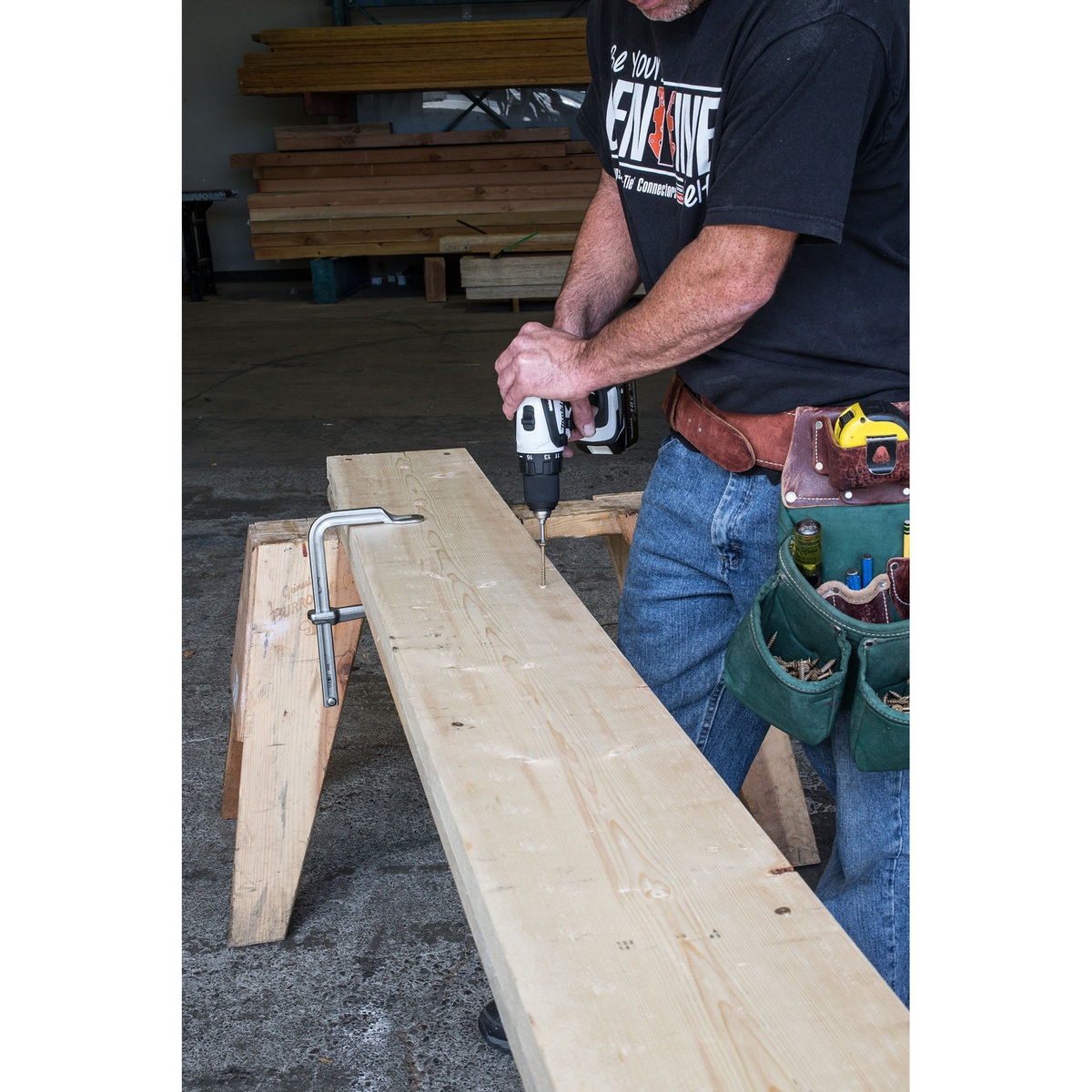 Simpson Strong-Tie SDWS16300QR150 Strong-Drive SDWS Framing Screw being driven into a large wood beam during framing work in a shop setting