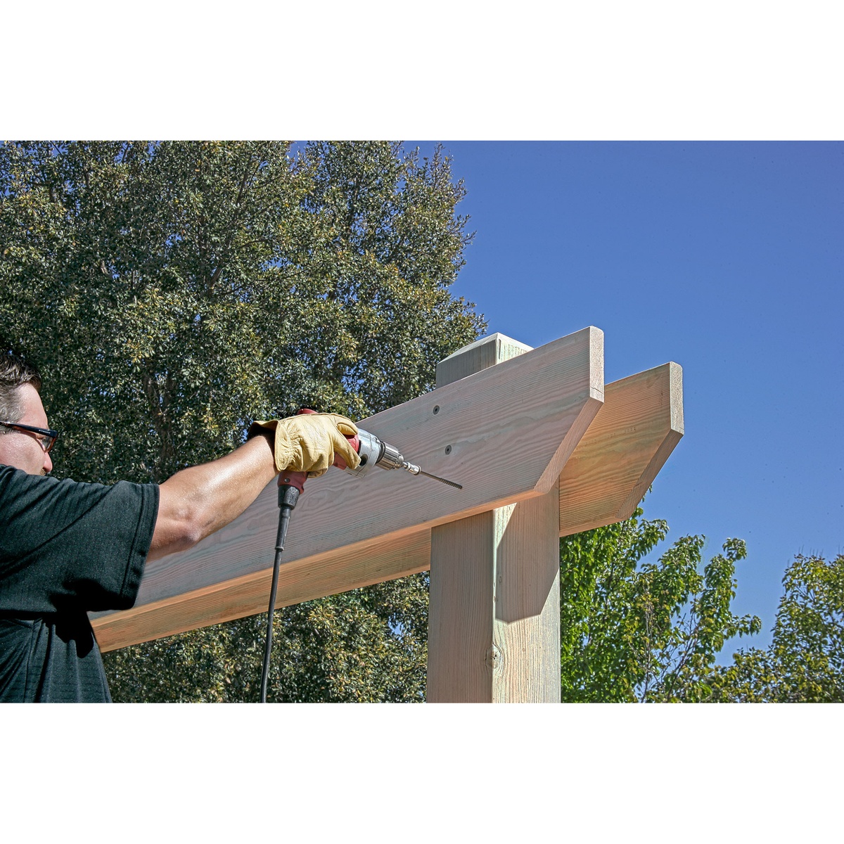 Simpson Strong-Tie SDWS22400DBMB Strong-Drive SDWS Timber Screws installing an exterior pergola beam connection outdoors under clear sky conditions