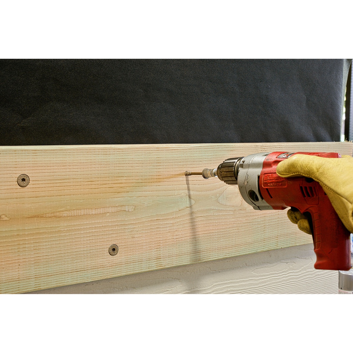 Simpson Strong-Tie SDWS22400DBMB Strong-Drive SDWS Timber Screws fastening a ledger board to framing with a drill during structural wood-to-wood installation