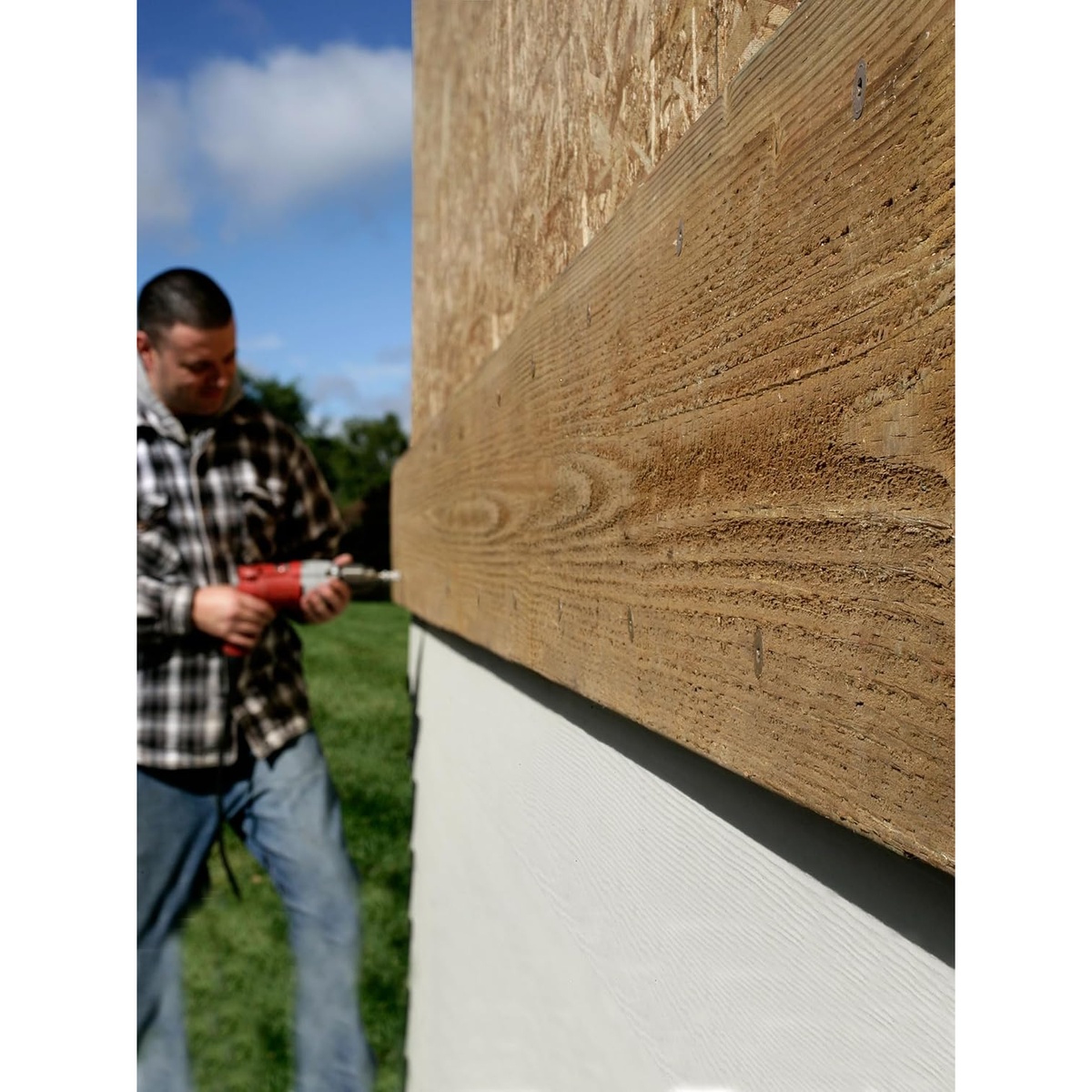 Simpson Strong-Tie SDWS22800DBMB Strong-Drive SDWS Timber Screws installed in an exterior wood ledger application on a building wall, showing structural wood-to-wood fastening in real jobsite use