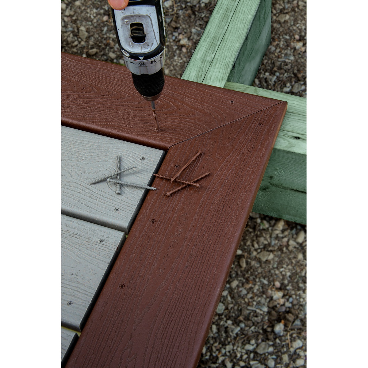 Simpson Strong-Tie Deck-Drive DCU COMPOSITE Screw, #10 x 2-3/4-in. T20, Quik Guard, Tan 01, 70-Pack being driven into composite deck boards on an outdoor deck frame during deck installation