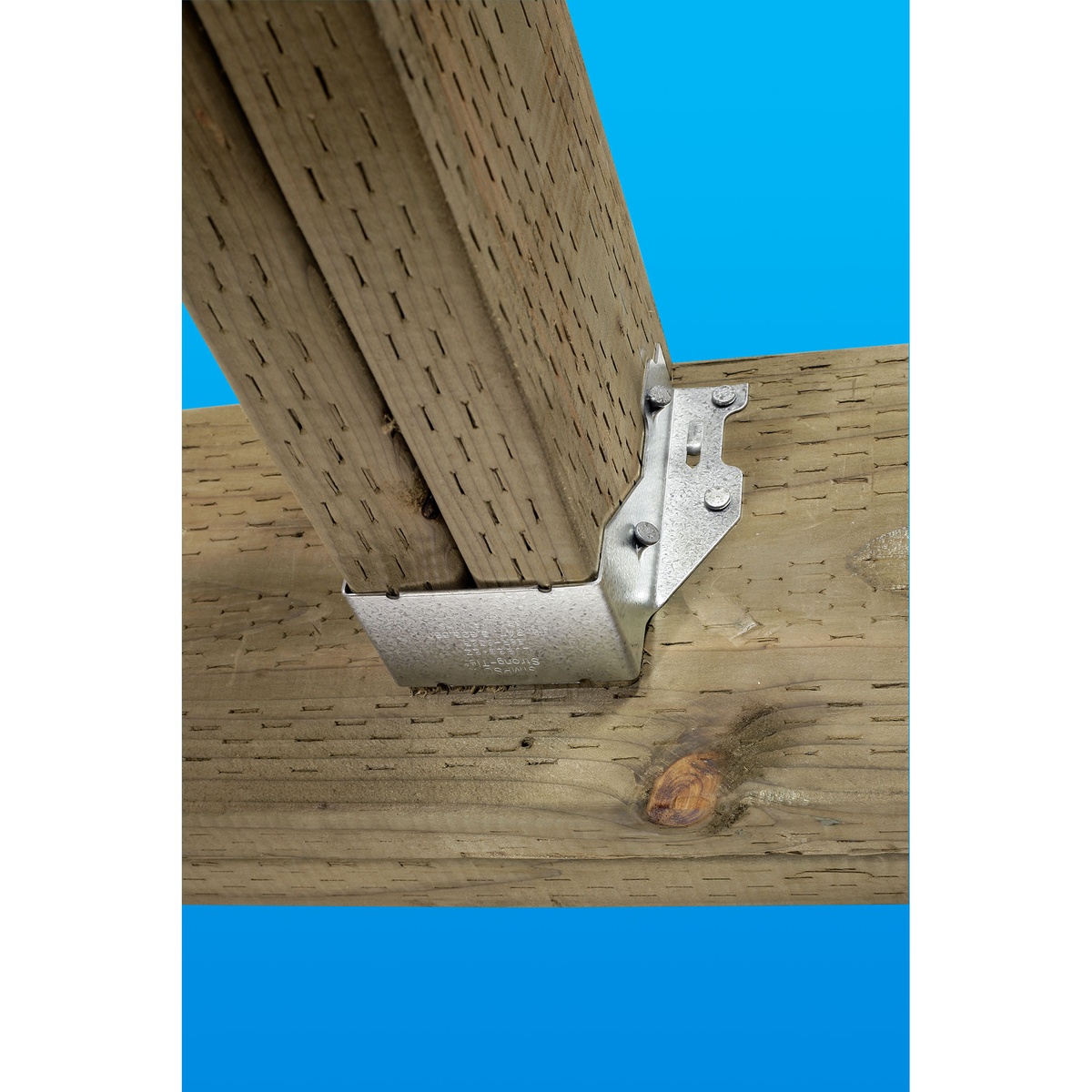 Simpson Strong-Tie LUS24Z face-mount joist hanger installed on treated wood framing supporting a joist at a beam connection in exterior construction