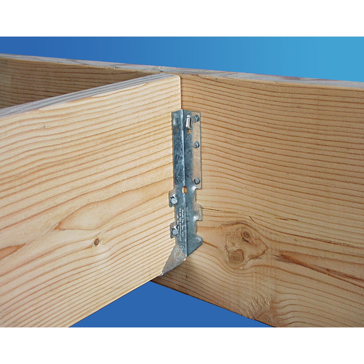 Simpson Strong-Tie LUS24Z face-mount joist hanger securing a wood joist to a header in a tight framing corner