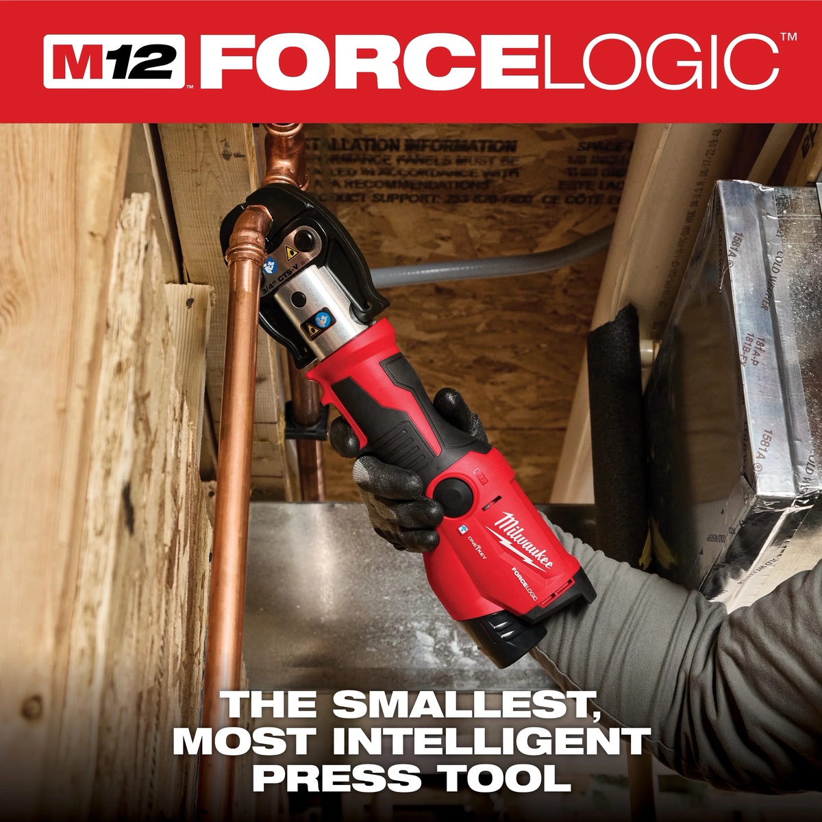 Milwaukee 2573-22 M12 FORCE LOGIC Press Tool Kit w/ ONE-KEY with 1/2 in. - 1 in. CTS-V Jaws pressing copper pipe in a framed mechanical space during plumbing installation