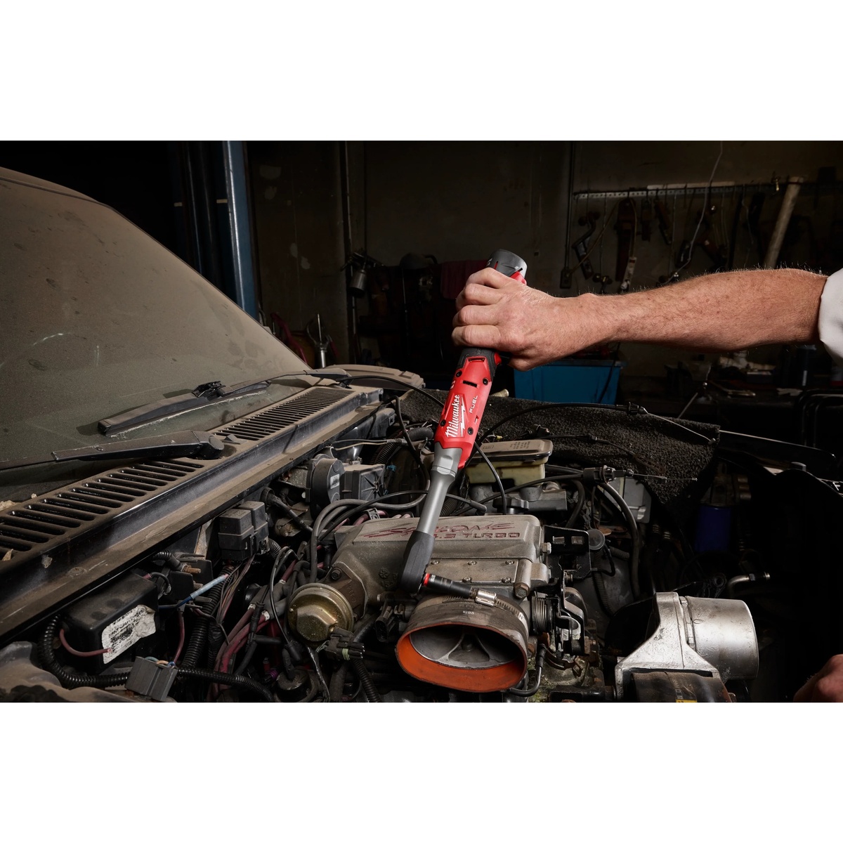 Milwaukee M12 FUEL 1/4 Inch Extended Reach Ratchet Protective Boot used on an extended reach ratchet while working inside an engine bay during automotive maintenance