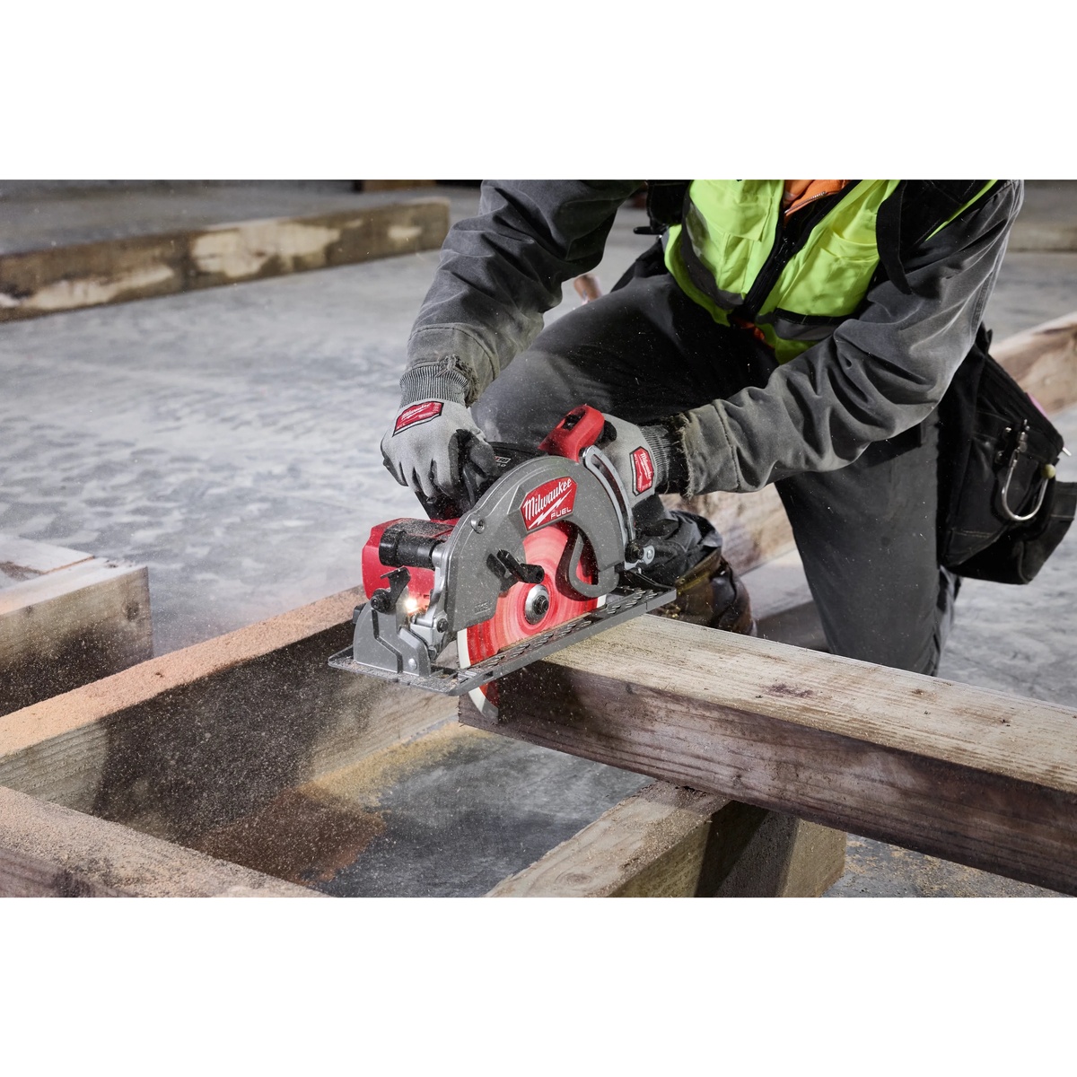 Milwaukee M18 FUEL 10-1/4 inch Rear Handle Circular Saw Kit cutting framing lumber on a construction jobsite during heavy carpentry work