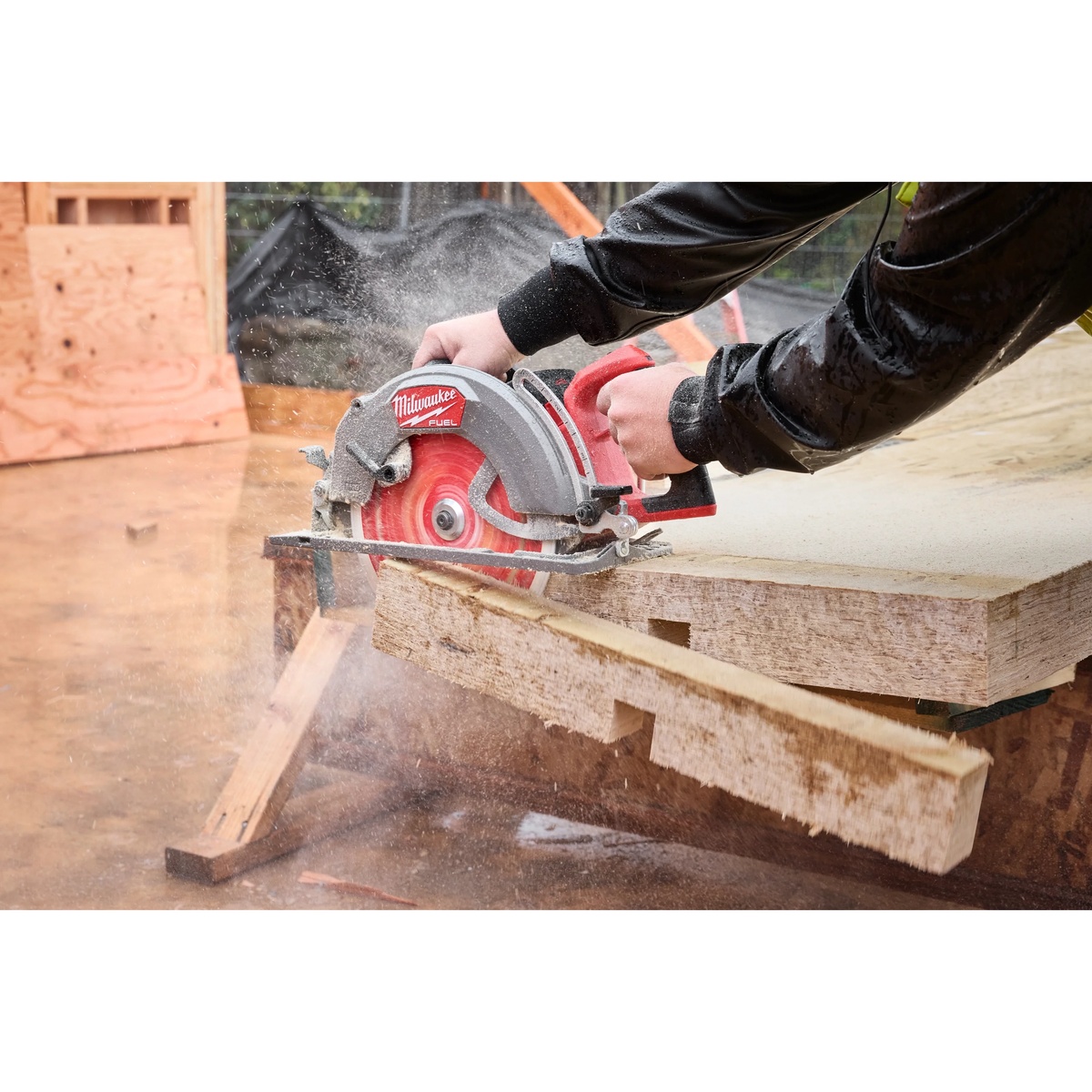 Milwaukee rear handle circular saw ripping framing lumber outdoors during deck or structural carpentry work