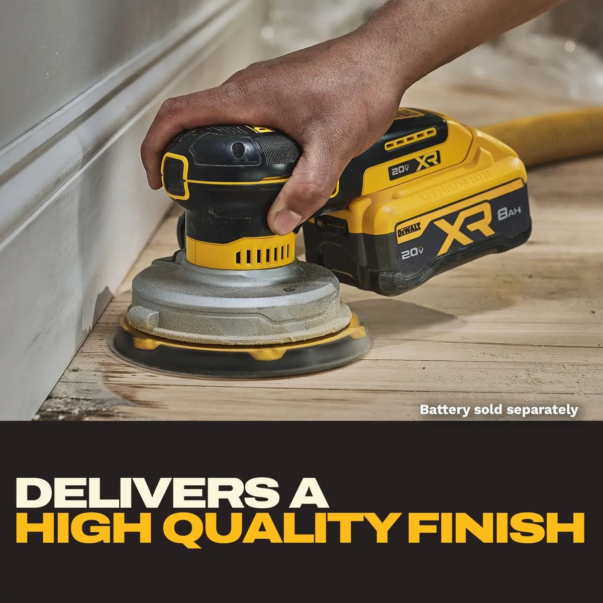 DEWALT DCW230B 20V XR 6-in Random Orbit Sander smoothing wood flooring along trim in a tight interior finish sanding application