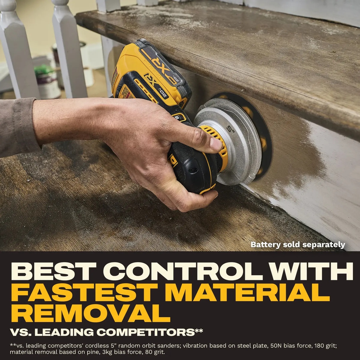 DEWALT DCW211B 20V XR 5-in Random Orbit Sander sanding a painted wood stair rail in a finish carpentry setting