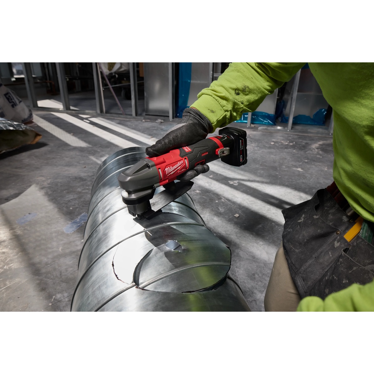Milwaukee M12 FUEL 16 Gauge Scroll Shear Replacement Blade Set supporting curved cuts on round sheet metal ductwork during HVAC installation