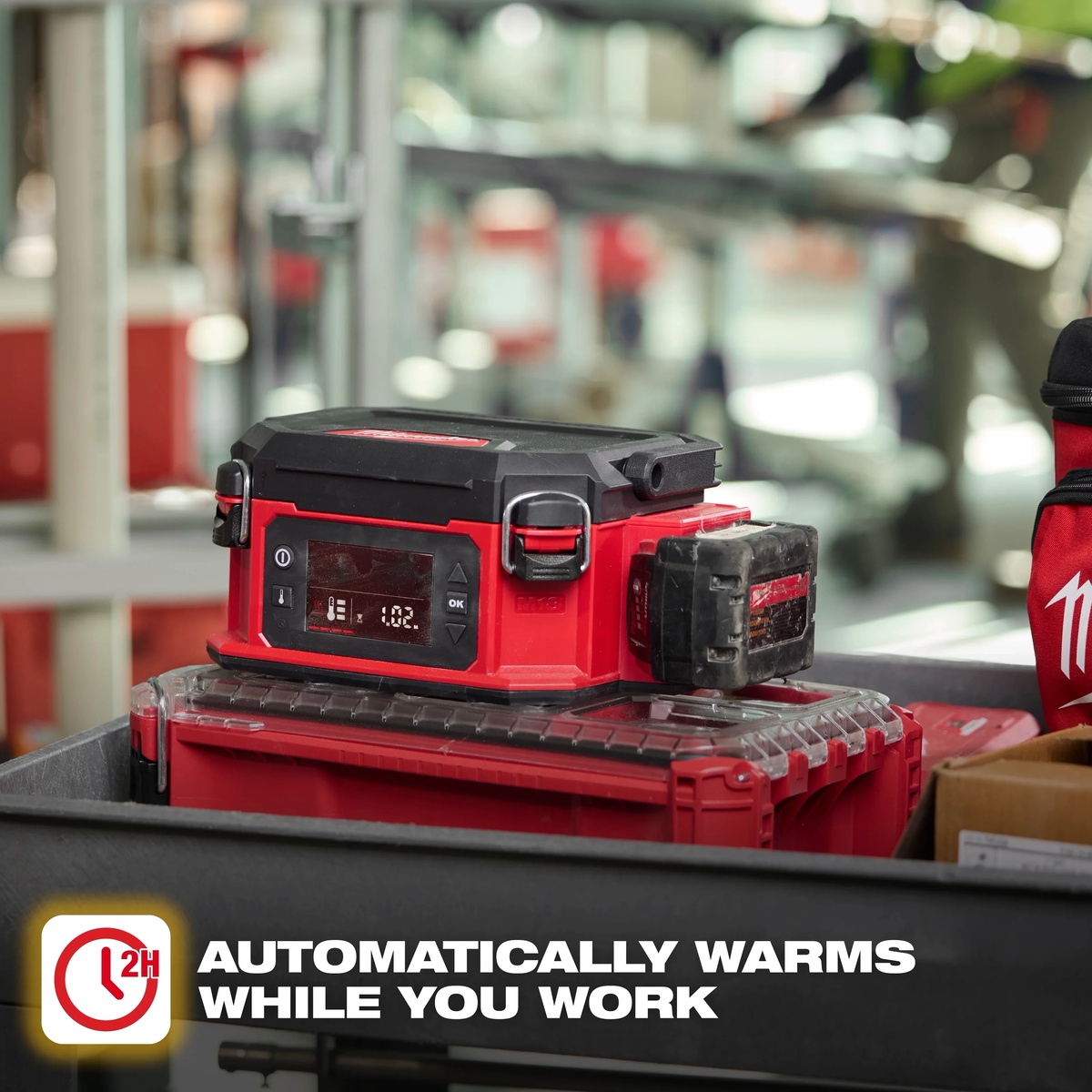 Milwaukee M18 PACKOUT Jobsite Lunch Warmer riding on PACKOUT storage in a work truck, warming a meal during a busy jobsite workday