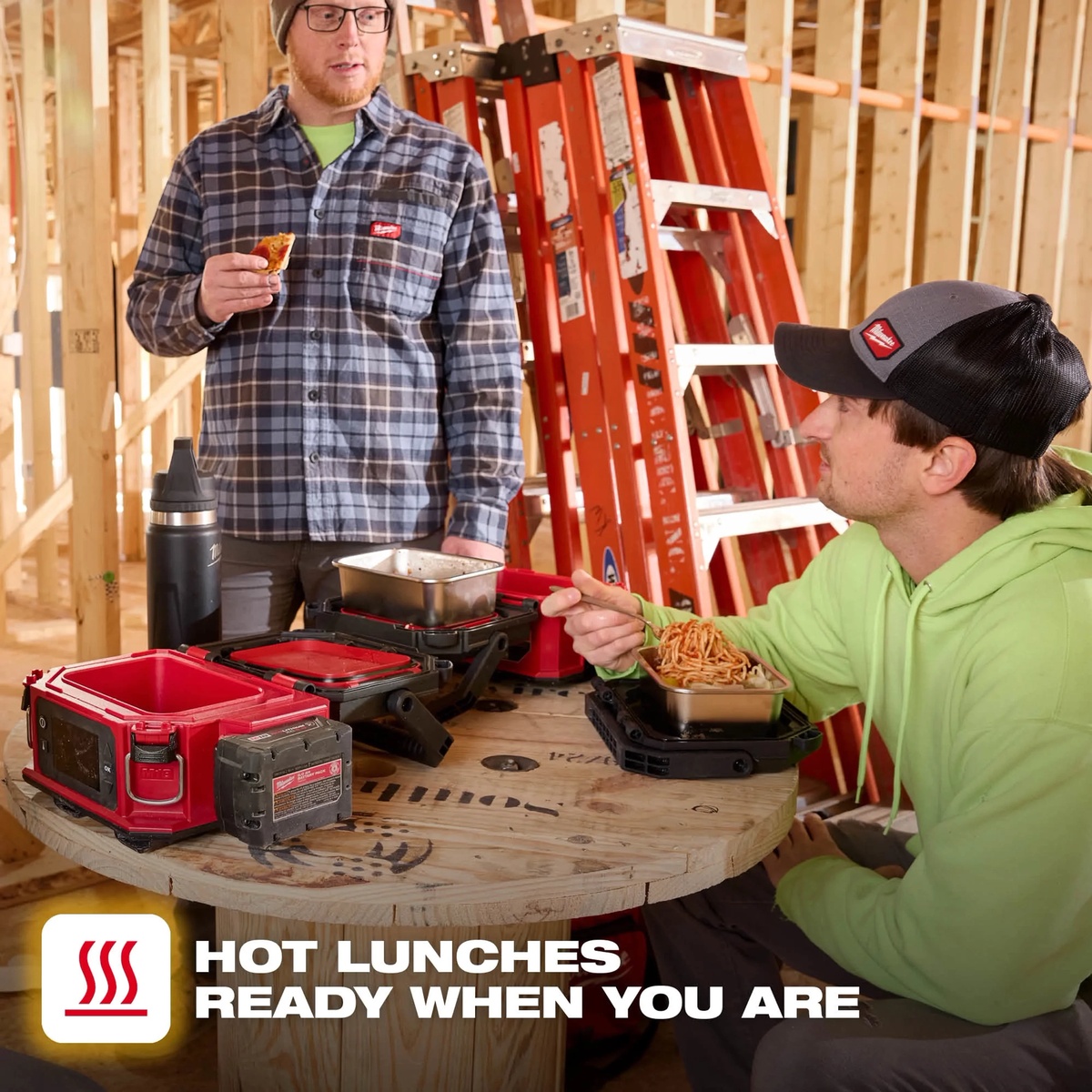 Milwaukee M18 PACKOUT Jobsite Lunch Warmer serving hot food from stainless steel containers on a framing jobsite during lunch break
