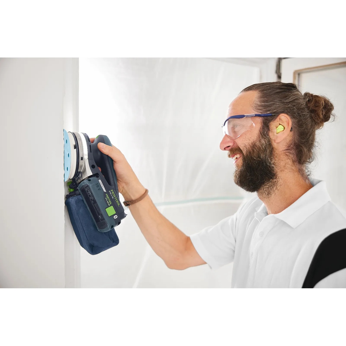 Festool SB-Longlife ETSC 2 Dust Collection Bag mounted on a Festool cordless sander during edge sanding on an interior wall