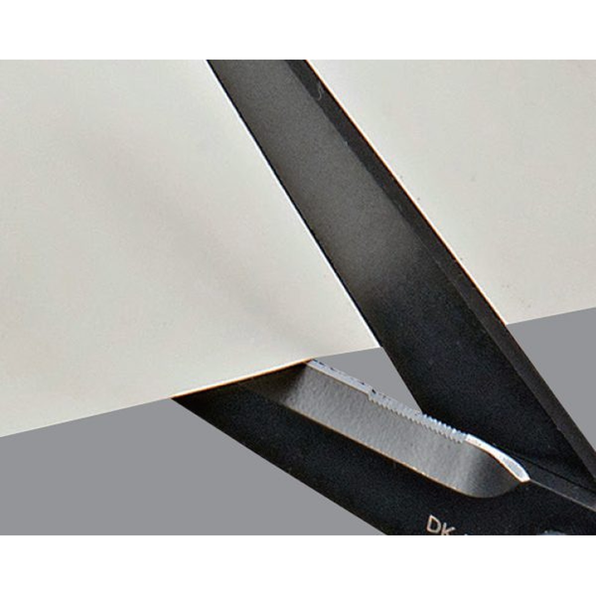 Tajima DK-BT70 VARIX Non-Stick Scissors blade close-up showing the cutting edge and serrated section used for adhesive tape and thin material work