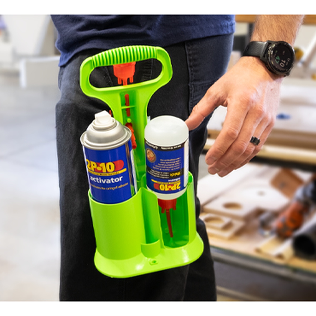 FastCap 2P-10 Caddy holding a 12 oz activator can and 10 oz 2P-10 Jel bottle upside down on a workbench setup for adhesive application