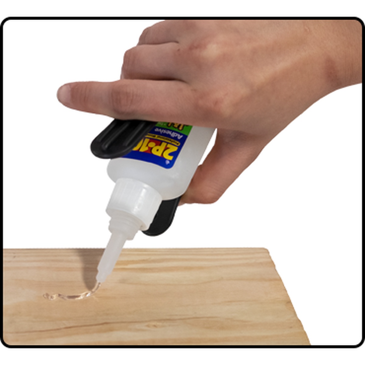 FastCap 2P-10 Easy Squeeze applying CA glue one-handed onto a wood board during a woodworking glue-up