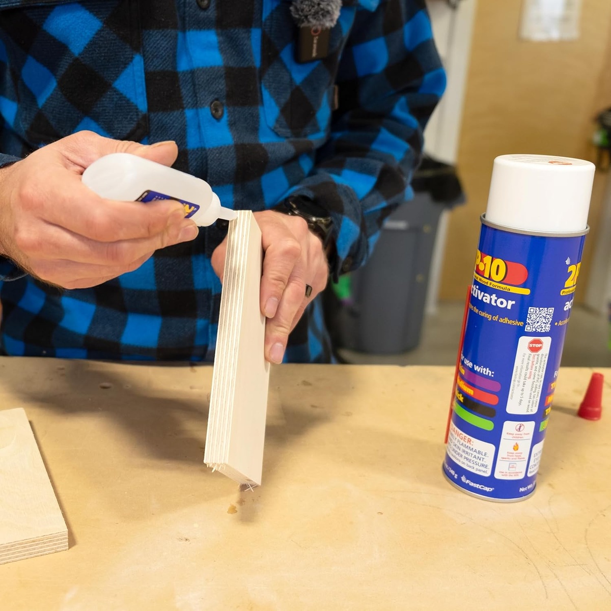 FastCap 2P-10 Solo Kit 2-oz. Thick Adhesive and 12-oz. Activator Bundle being applied to a plywood edge during woodworking assembly on a workbench