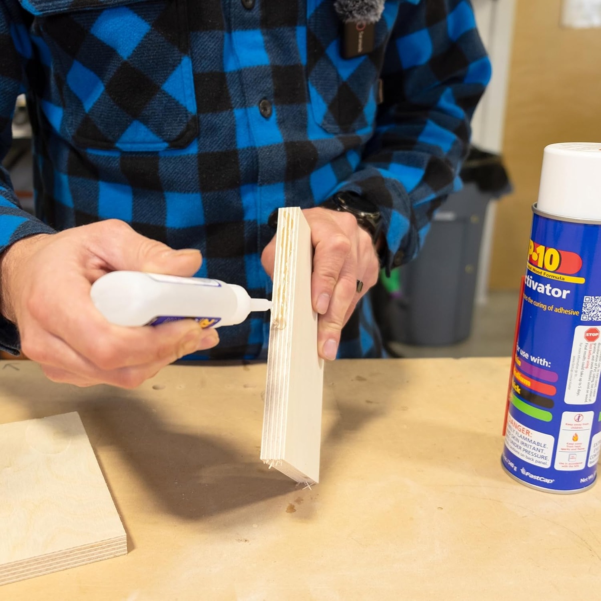 FastCap 2P-10 Solo Kit thick adhesive bottle applying glue to a vertical plywood edge for cabinet or trim assembly