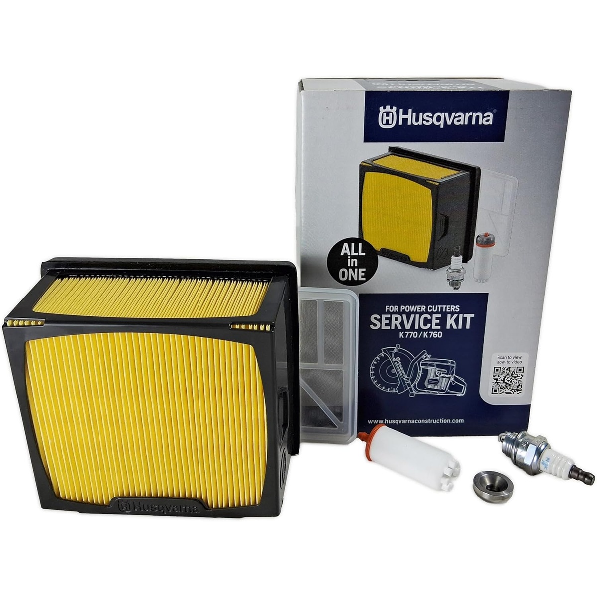 Husqvarna 546903001 Service Kit with air filter, mesh filter, fuel filter, and spark plug laid out for power cutter maintenance on a clean workbench