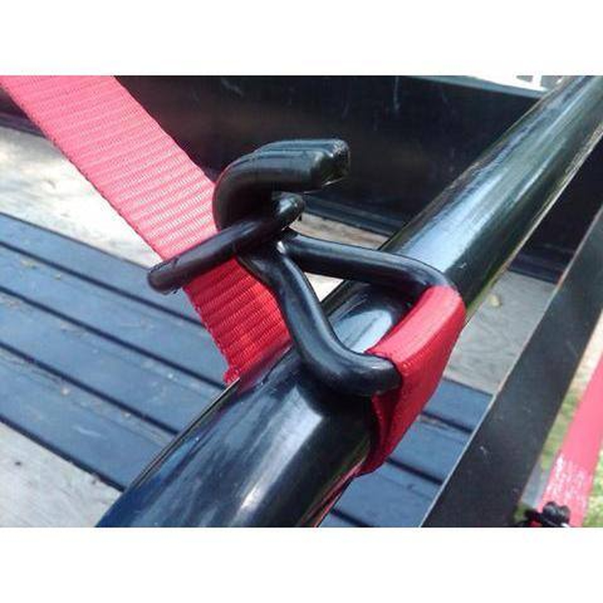 Quickloader QL300003 Retractable Ratchet Tie Down Strap double J-hook attached to a trailer rail during cargo tie-down work