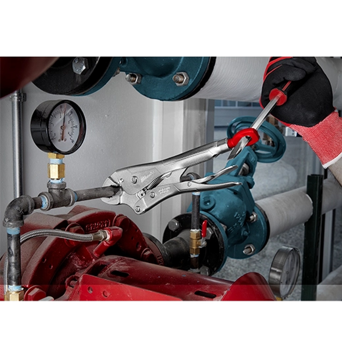 Milwaukee 48-22-3523 9 inch deep reach swivel locking C-clamp holding pipe on mechanical equipment during plumbing or maintenance work