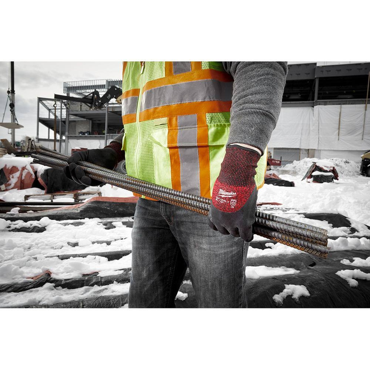 Milwaukee 48-22-8920 Cut Level 3 Winter Insulated Gloves handling rebar on a snowy construction site in cold outdoor conditions