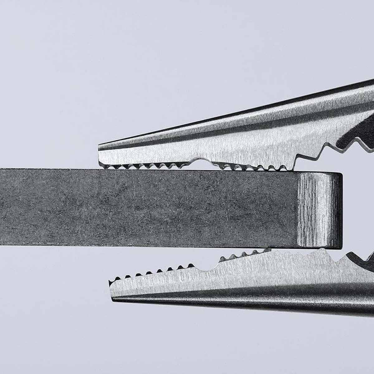 Knipex 08 21 145 SBA Needle Nose Combination Pliers gripping a flat metal bar to show the jaw contour and holding control