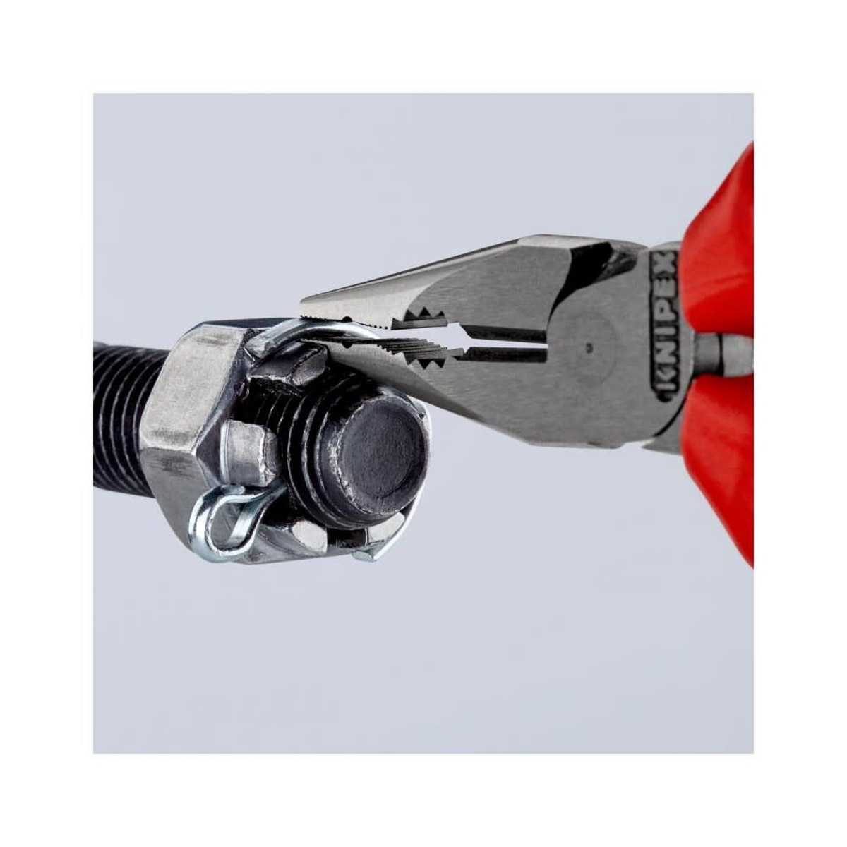 Knipex Needle Nose Combination Pliers 145mm gripping a bolt and small hardware during repair work, showing secure hold in a tight mechanical assembly