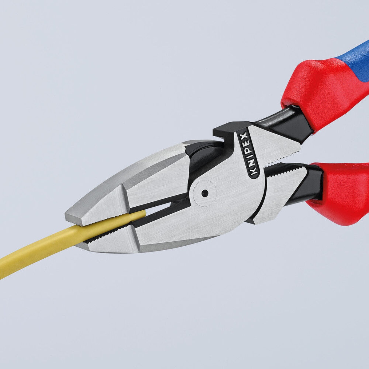 Knipex 09 02 240 SBA Lineman's Pliers gripping insulated wire in a close-up application shot for electrical work
