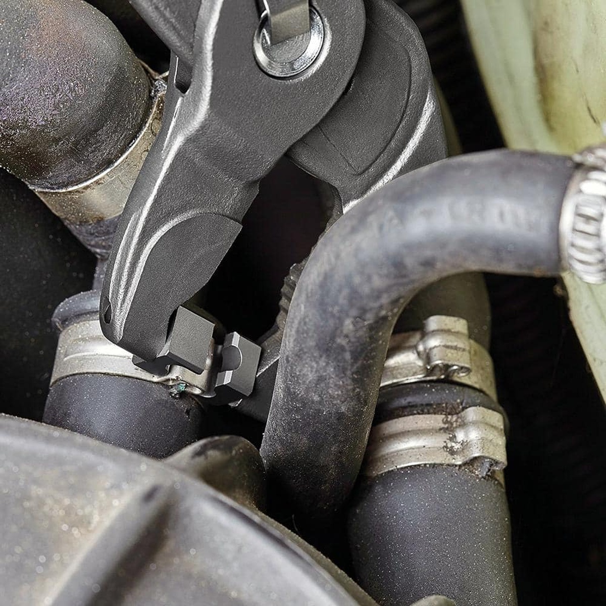 Knipex 85 51 250 C SBA hose clamp pliers working on a hose clamp inside a tight engine bay