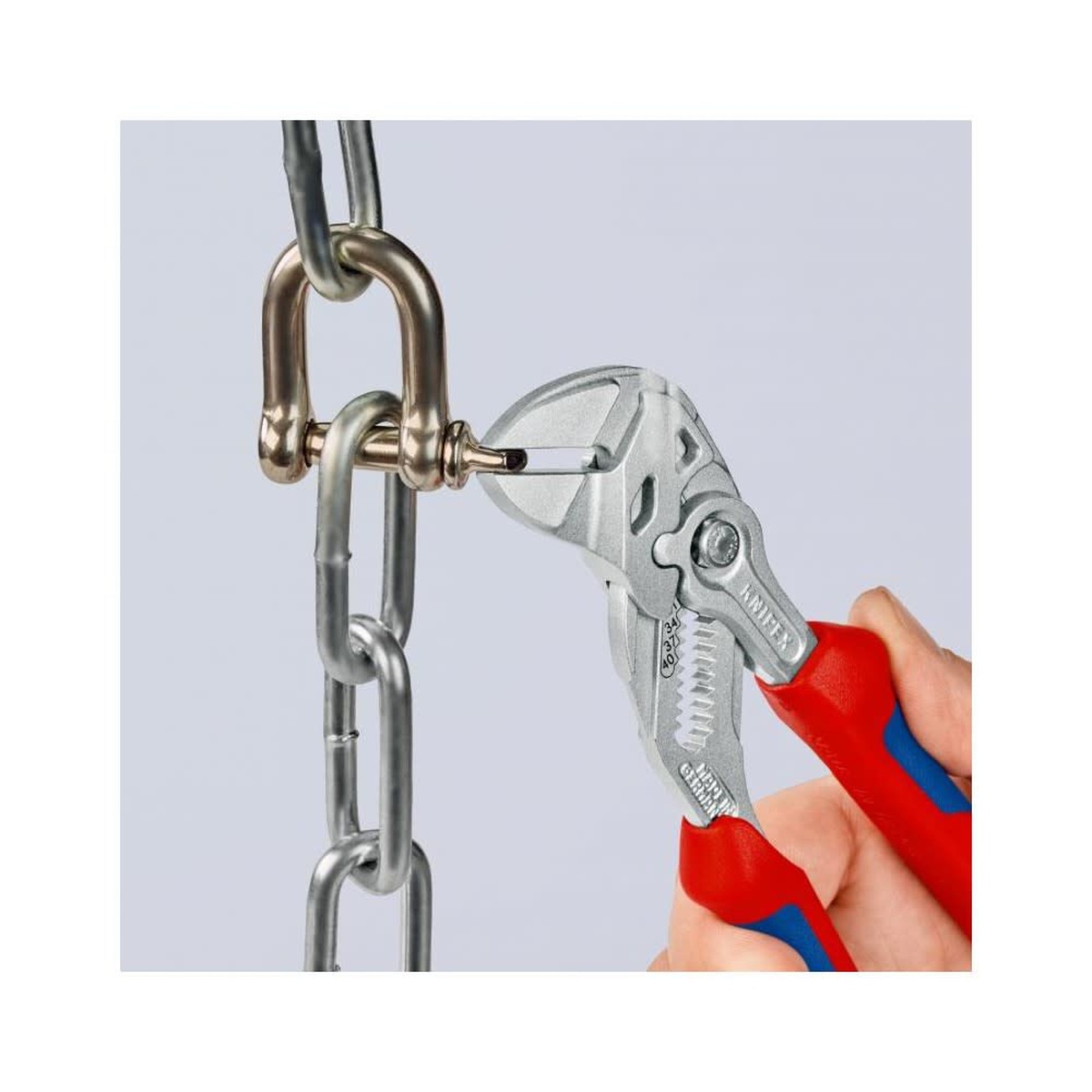 Knipex Chrome Plated Head Pliers Wrench 180mm gripping a chain fitting in close-up during adjustment work on finished metal hardware